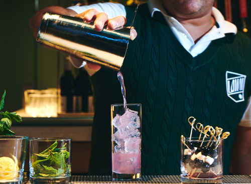 Lawn Club bartender pouring a cocktail